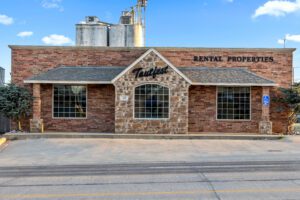 Brick rental office building with silos behind